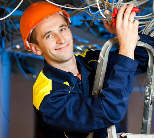 Construction repairman with a combination pliers on a stepladder